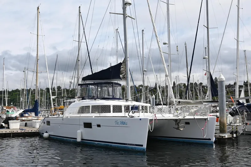 The Image of 2009 Lagoon 440 catamaran docked at a marina with surrounding sailboats. - 1