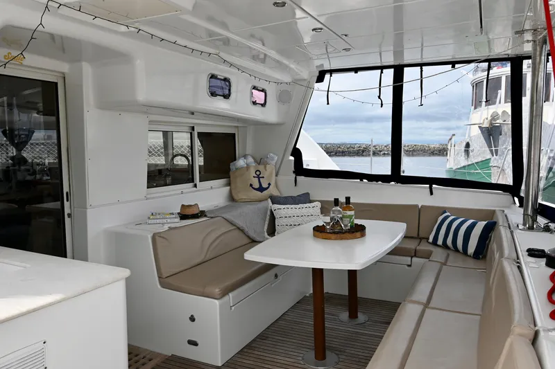 Slide: The Image of Interior of 2009 Lagoon 440 catamaran with cozy seating and nautical decor. - 15