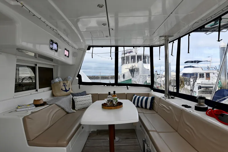 Slide: The Image of Interior of 2009 Lagoon 440 catamaran with cozy seating and nautical decor. - 16
