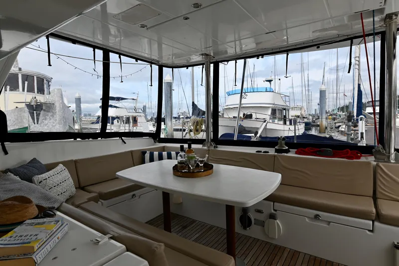 Slide: The Image of Interior of 2009 Lagoon 440 catamaran with seating area and marina view. - 18