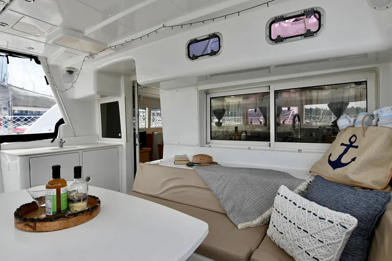 Slide: The Image of Interior of 2009 Lagoon 440 catamaran with cozy seating and nautical decor. - 19