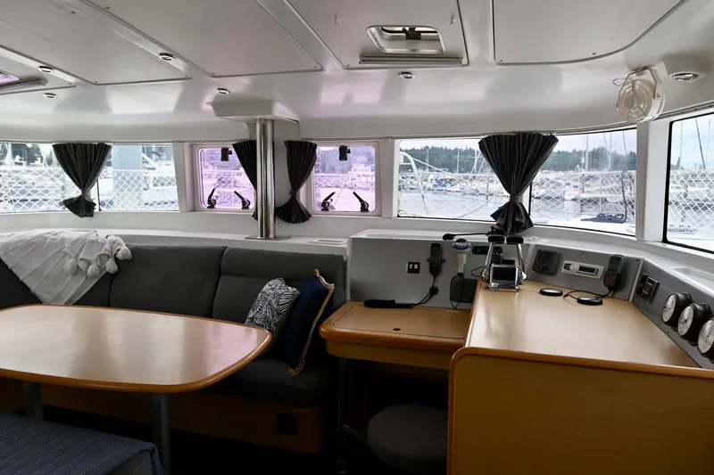 Slide: The Image of Interior of 2009 Lagoon 440 catamaran with seating area and navigation station. - 21