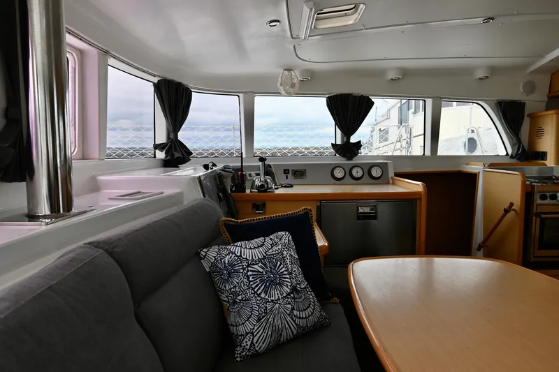 Slide: The Image of Interior of 2009 Lagoon 440 catamaran with modern seating and navigation equipment. - 23