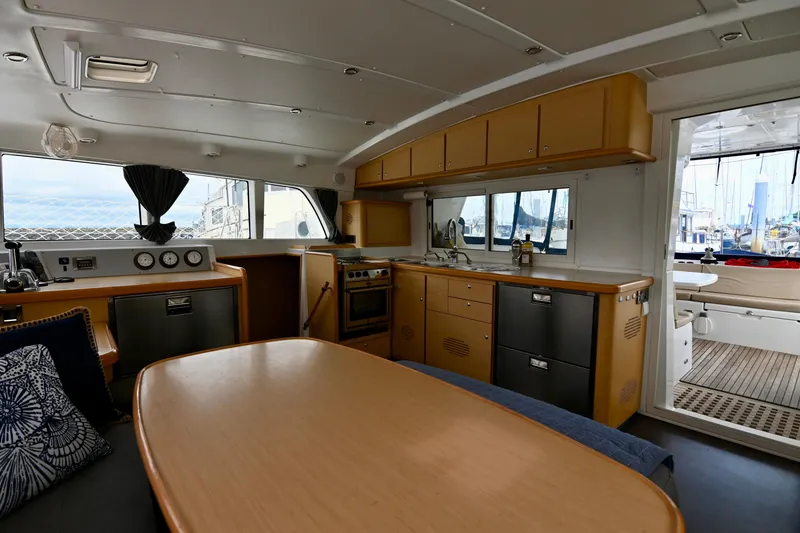 Slide: The Image of Interior of 2009 Lagoon 440 catamaran with modern kitchen and dining area. - 24