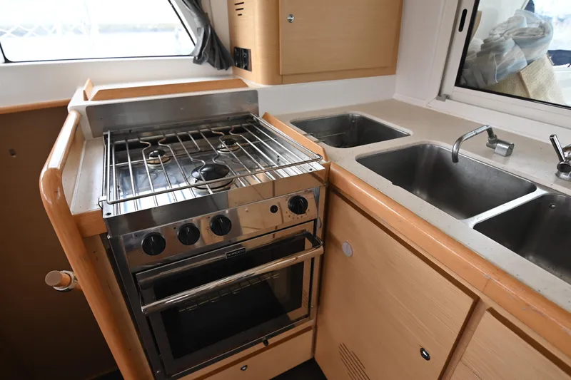 Slide: The Image of Interior kitchen of 2009 Lagoon 440 catamaran with stove and dual sinks. - 26