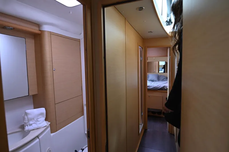 Slide: The Image of Interior of 2009 Lagoon 440 yacht showing hallway, bathroom, and bedroom. - 34