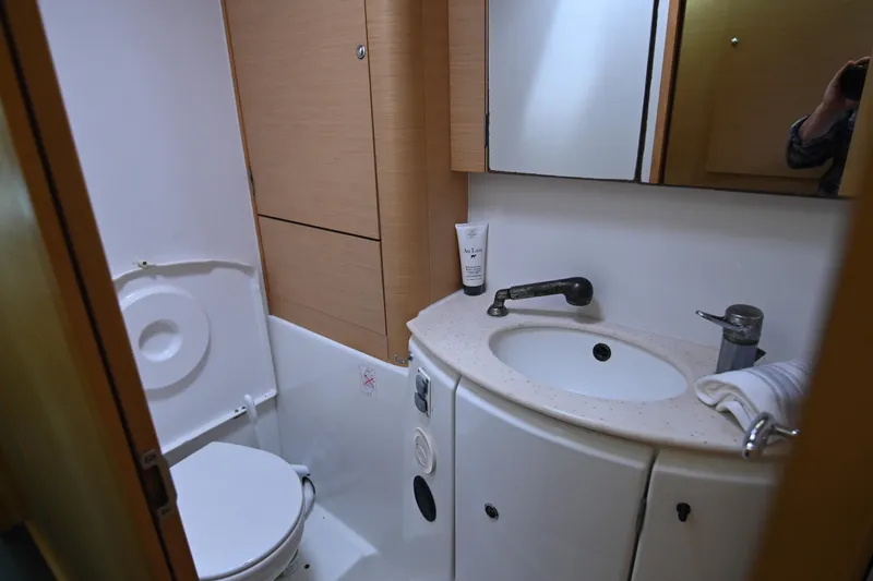 Slide: The Image of Compact bathroom in a 2009 Lagoon 440 yacht with sink, toilet, and storage. - 35
