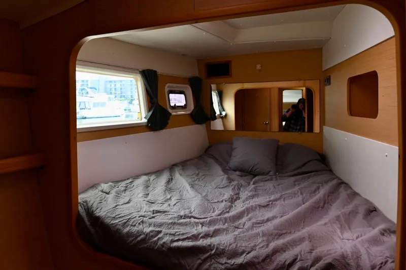 Slide: The Image of Cozy cabin interior of 2009 Lagoon 440 catamaran with bed and windows. - 36