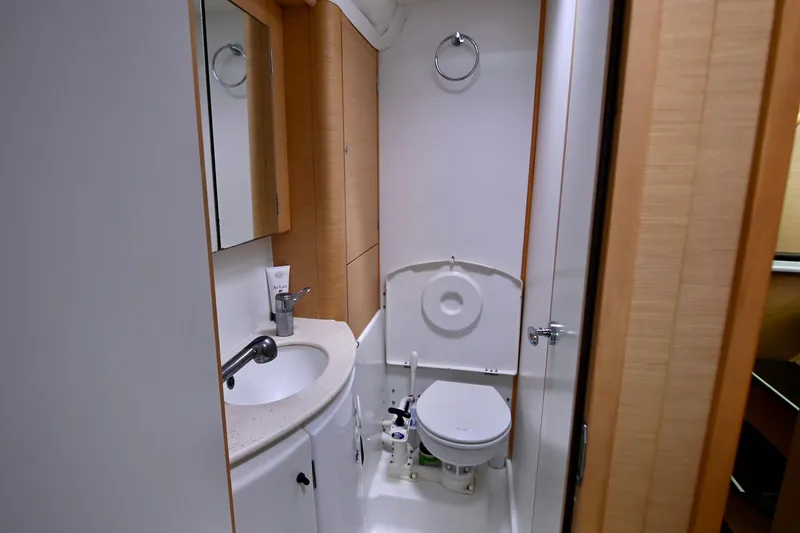 Slide: The Image of Bathroom interior of 2009 Lagoon 440 yacht, featuring sink, mirror, and toilet. - 37