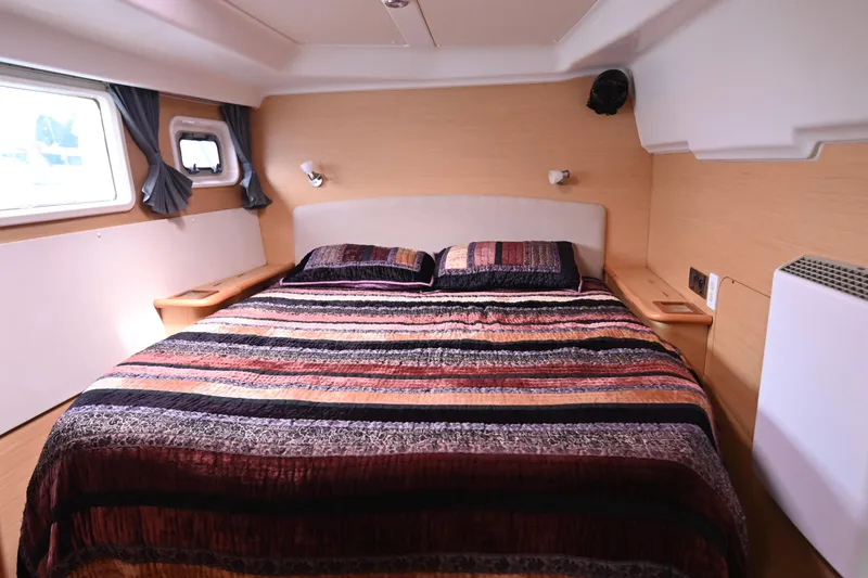 Slide: The Image of Luxurious bedroom interior of 2009 Lagoon 440 yacht with striped bedding and modern design. - 39