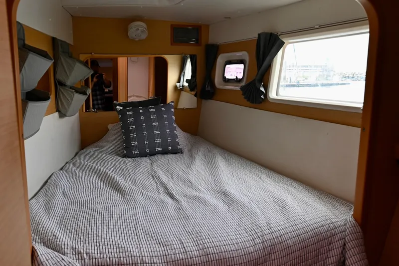 Slide: The Image of Cozy cabin interior of 2009 Lagoon 440 catamaran with bed and window view. - 41
