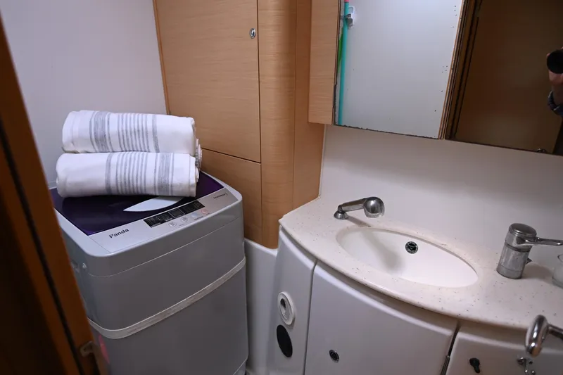 Slide: The Image of Compact bathroom in 2009 Lagoon 440 yacht with sink, mirror, and washing machine. - 42