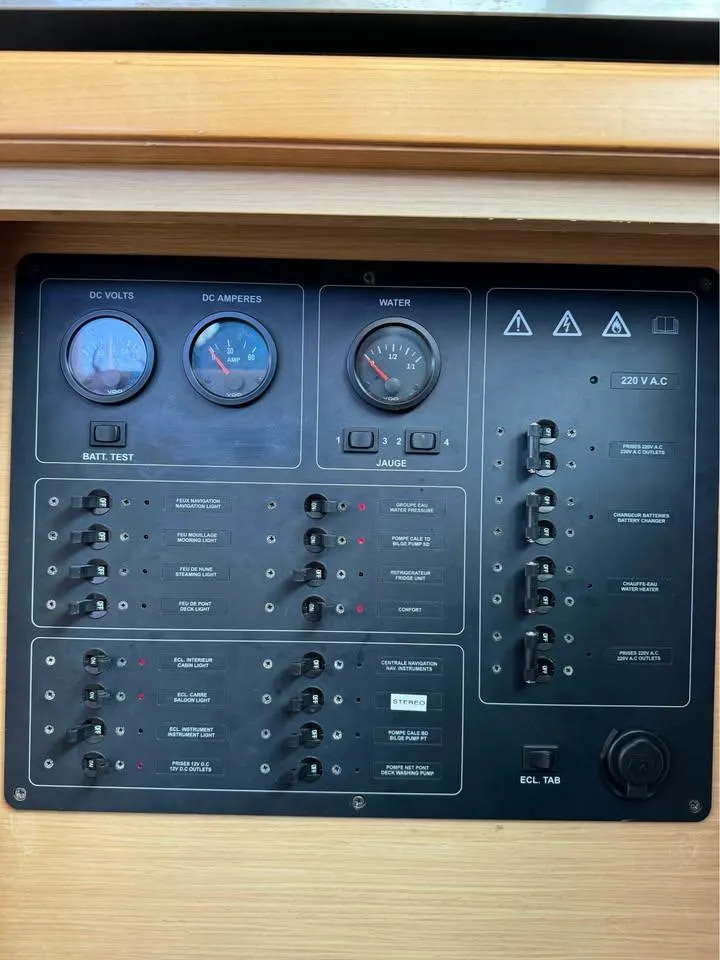 Slide: The Image of Electrical control panel of a 2009 Lagoon 440 catamaran with gauges and switches. - 44