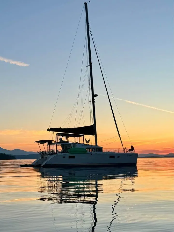 Slide: The Image of 2009 Lagoon 440 catamaran at sunset on calm water. - 47