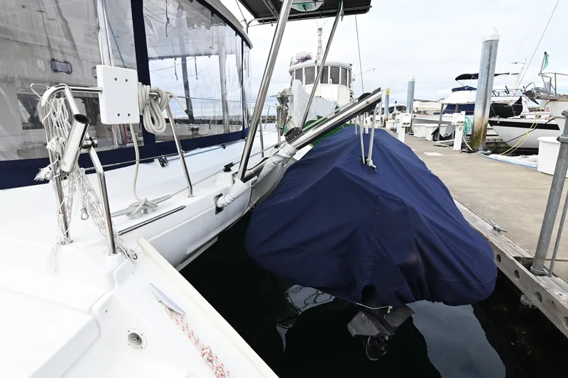 Slide: The Image of 2009 Lagoon 440 yacht docked with covered equipment, marina background. - 6