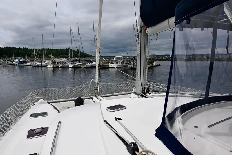 Slide: The Image of Lagoon 440 catamaran from 2009 docked in a marina with overcast skies. - 8