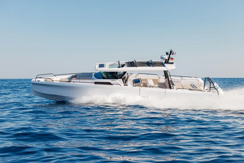 The Image of 2025 Axopar 45 Cross Top cruising on open water, showcasing sleek design and performance. - 0