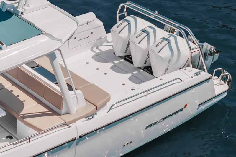 Slide: The Image of 2026 Axopar 45 Cross Top boat with triple Mercury engines on blue water. - 18