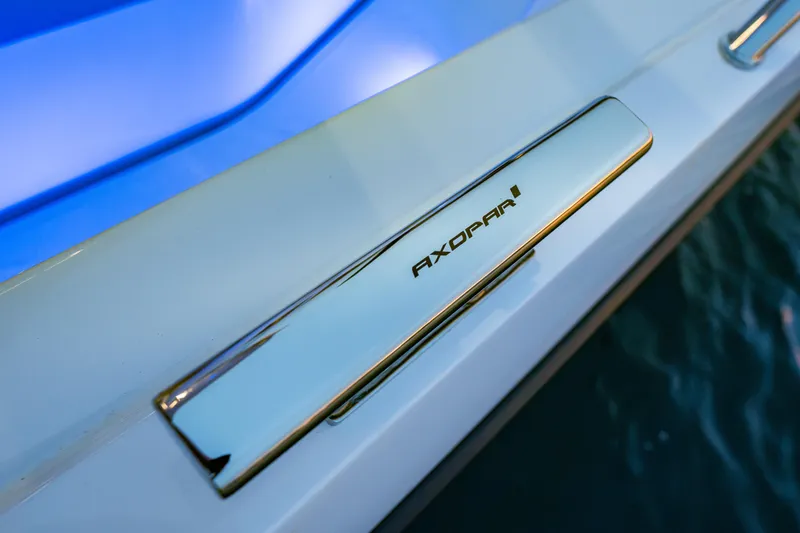 Slide: The Image of 2026 Axopar 45 Cross Top boat detail with sleek chrome handle and logo. - 48
