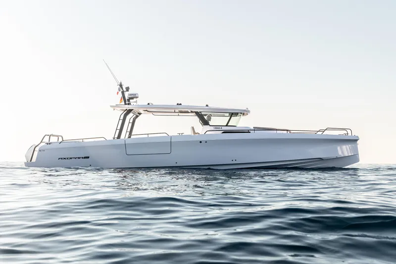 Slide: The Image of 2025 Axopar 45 Cross Top boat on calm ocean waters. - 2