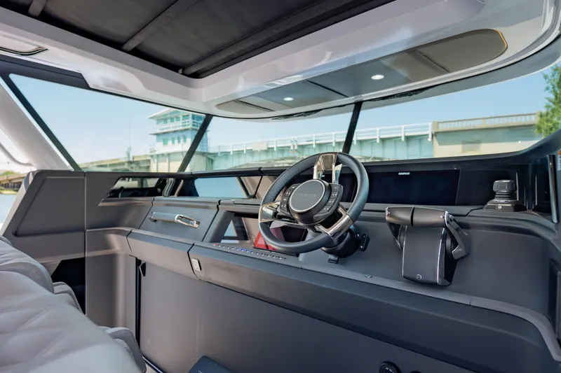 Slide: The Image of Interior view of 2026 Axopar 45 Cross Top boat cockpit with modern steering and controls. - 32