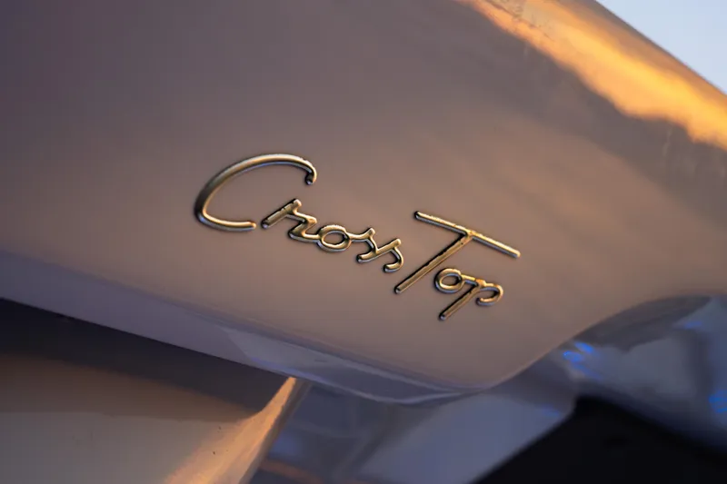 Slide: The Image of Close-up of 2026 Axopar 45 Cross Top logo on boat exterior. - 38