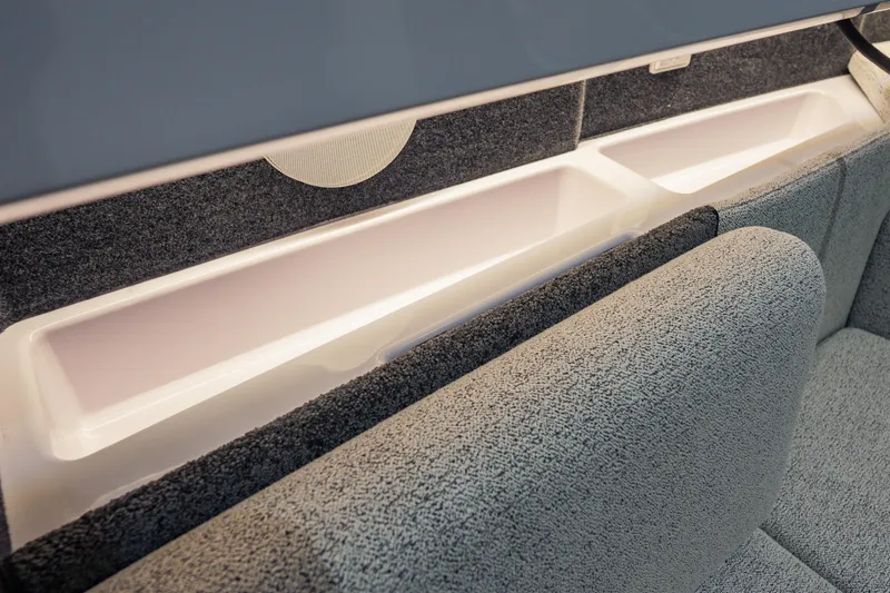 Slide: The Image of Interior storage compartment of 2026 Axopar 45 Cross Top boat, featuring sleek design and upholstery. - 57