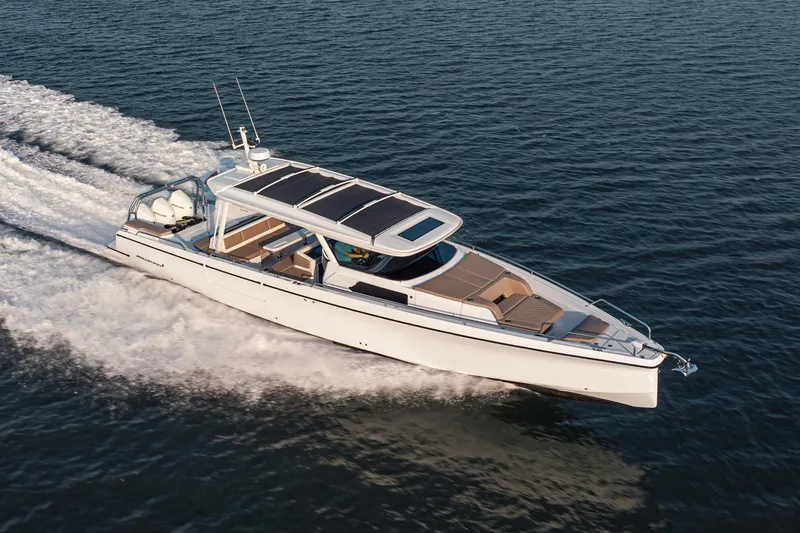 Slide: The Image of 2026 Axopar 45 Cross Top cruising on open water, showcasing sleek design and performance. - 10