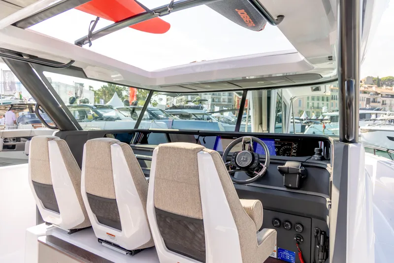 Slide: The Image of 2025 Axopar 45 Cross Top boat interior with modern helm and seating. - 6