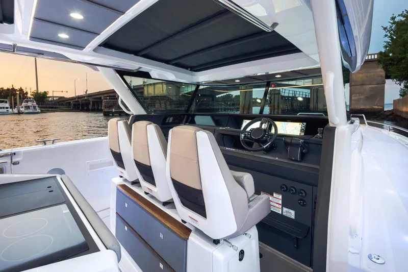 Slide: The Image of Interior view of 2026 Axopar 45 Cross Top boat with modern helm and seating. - 31