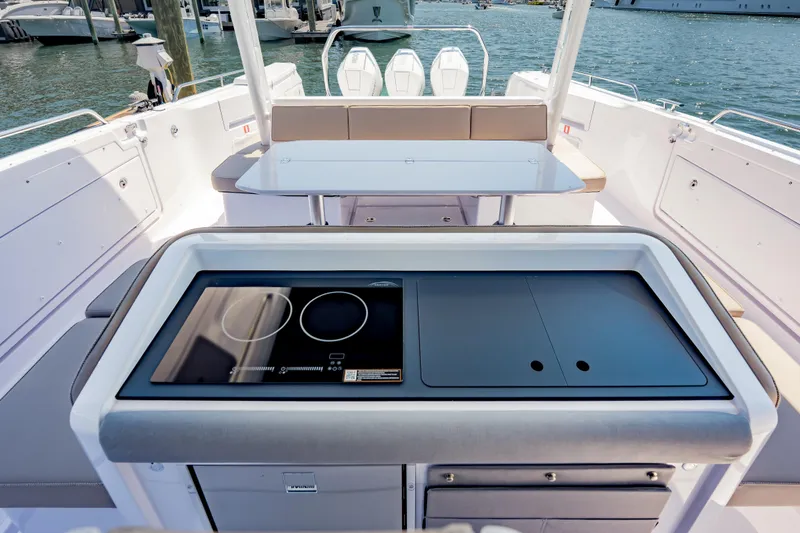 Slide: The Image of 2026 Axopar 45 Cross Top boat interior with modern kitchen and seating area. - 41