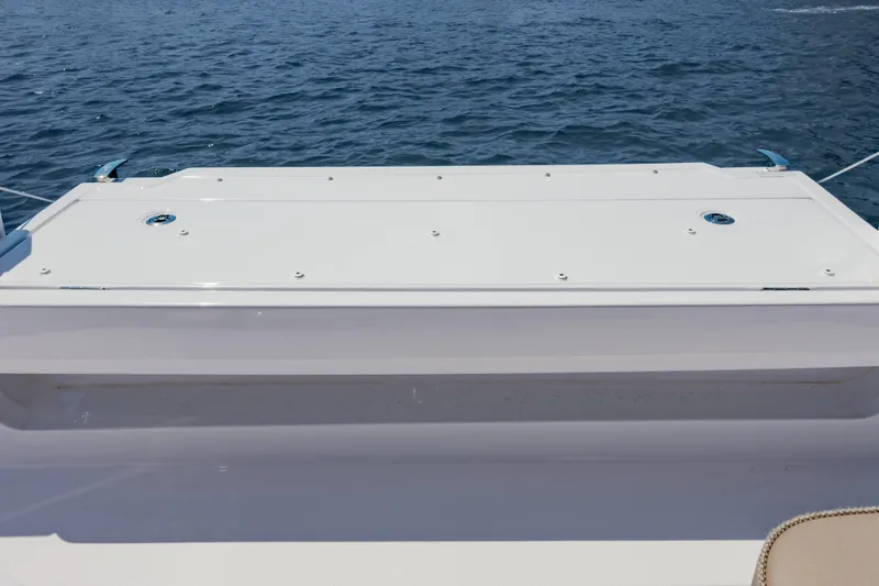 Slide: The Image of 2026 Axopar 45 Cross Top boat deck with ocean backdrop. - 44