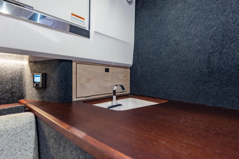 Slide: The Image of Interior of 2026 Axopar 45 Cross Top, featuring a sleek sink and modern design. - 58