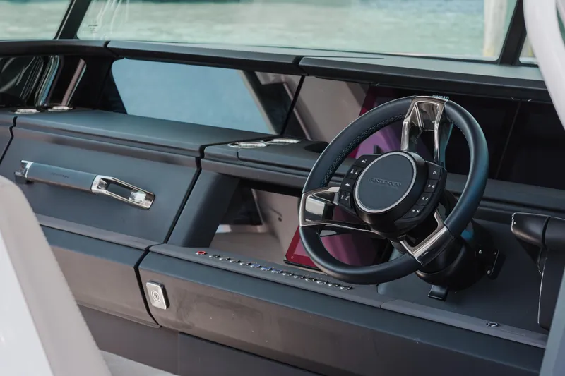 Slide: The Image of Interior view of 2026 Axopar 45 Cross Top boat's sleek steering console. - 33