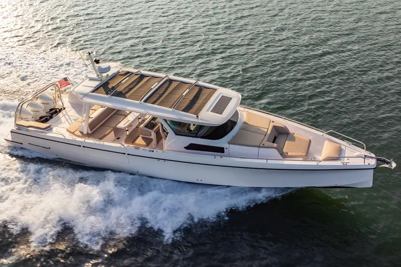 Slide: The Image of 2026 Axopar 45 Cross Top cruising on open water, showcasing sleek design and performance. - 12