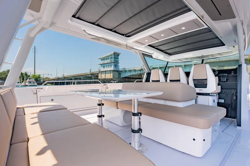 Slide: The Image of Luxurious interior of 2026 Axopar 45 Cross Top boat with seating and table. - 30