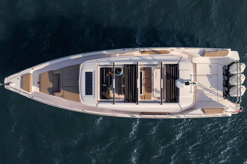 Slide: The Image of Top view of 2026 Axopar 45 Cross Top boat on water. - 9