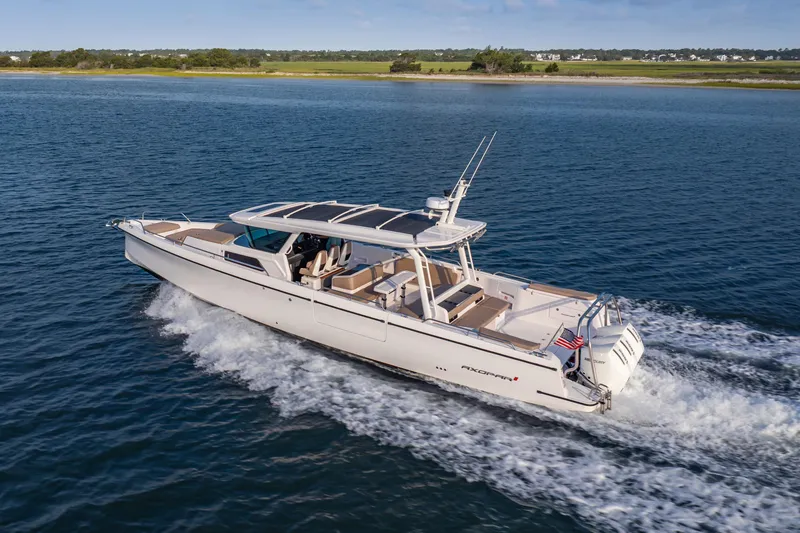 Slide: The Image of 2026 Axopar 45 Cross Top cruising on open water, showcasing sleek design and performance. - 7