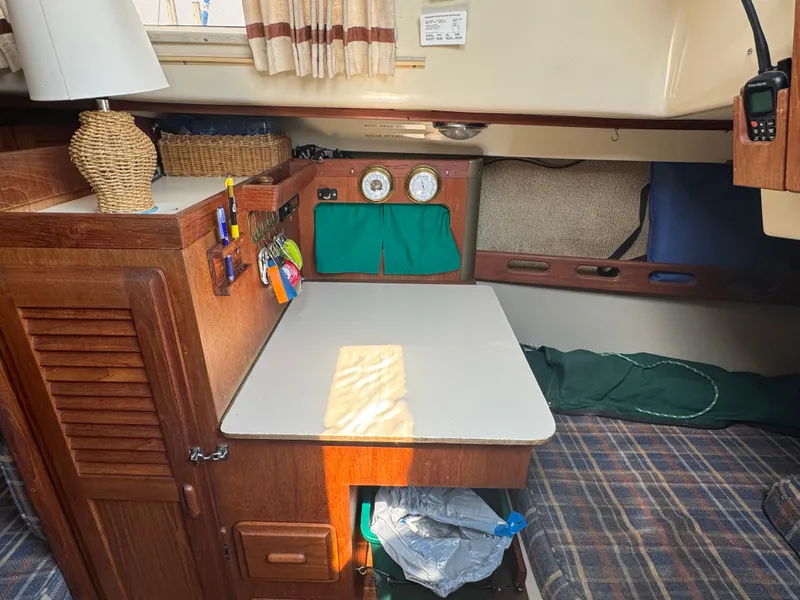 Slide: The Image of Interior of a 1984 O'Day 34 Sloop with a cozy cabin and wooden furnishings. - 11