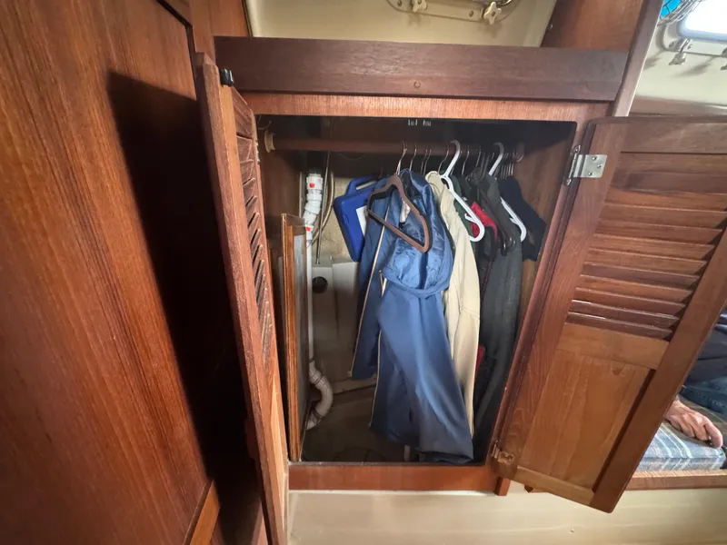 Slide: The Image of Wooden closet with hanging clothes inside an O'Day 34 Sloop, 1984 model. - 17
