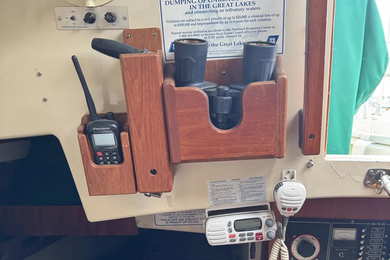 Slide: The Image of 1984 O'Day 34 Sloop interior with radio, binoculars, and control panel. - 18