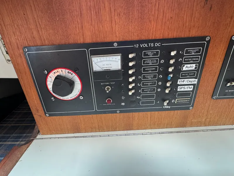Slide: The Image of Electrical control panel of a 1984 O'Day 34 Sloop sailboat, featuring switches and gauges. - 19