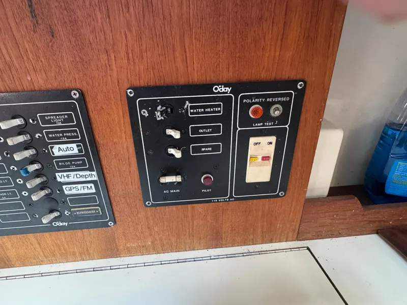 Slide: The Image of Control panel of a 1984 O'Day 34 Sloop sailboat with various switches and indicators. - 20