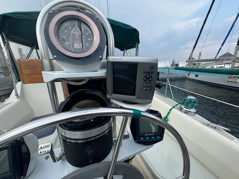 Slide: The Image of 1984 O'Day 34 Sloop cockpit with navigation instruments and steering wheel. - 23