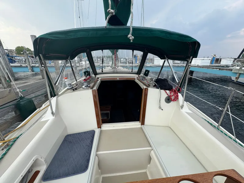 Slide: The Image of 1984 O'Day 34 Sloop sailboat cockpit with green canopy at marina. - 24