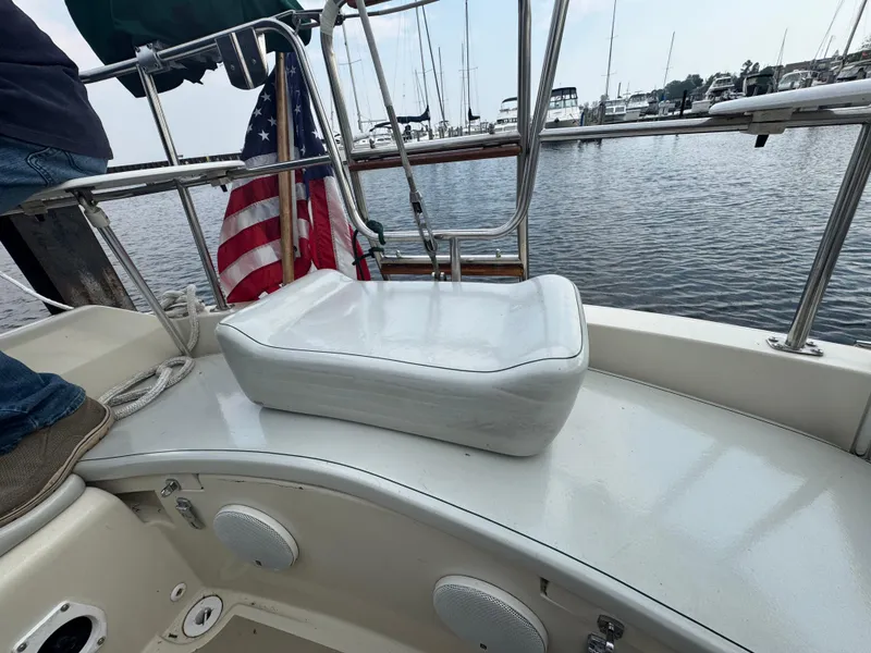 Slide: The Image of 1984 O'Day 34 Sloop cockpit with American flag and marina view. - 25