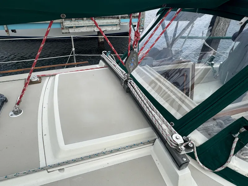 Slide: The Image of 1984 O'Day 34 Sloop sailboat deck with green canopy and red ropes. - 27
