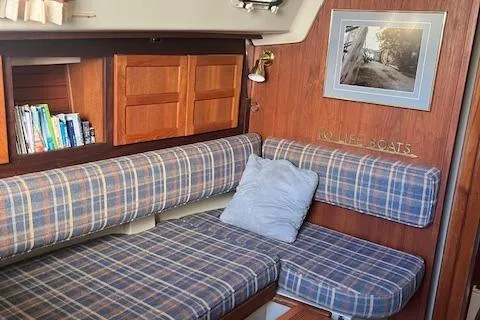 Slide: The Image of Interior of 1984 O'Day 34 Sloop with plaid seating and wooden cabinetry. - 3