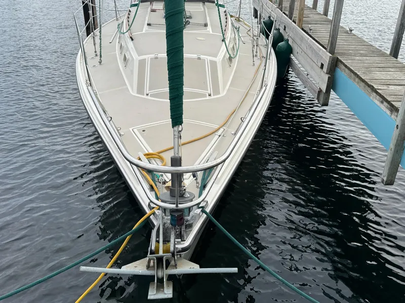 Slide: The Image of 1984 O'Day 34 Sloop docked, showing bow and deck details. - 31