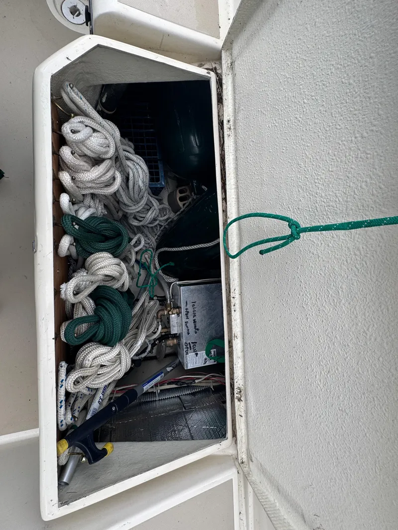 Slide: The Image of Storage compartment on 1984 O'Day 34 Sloop with ropes and equipment. - 32